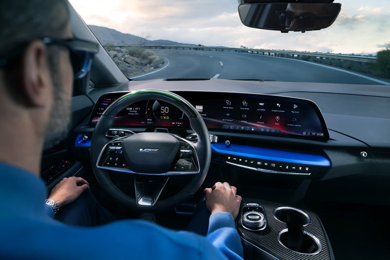 Front View of the 2026 OPTIQ-V Driving Through the Dusk Utilizing its Headlights | Tom Naquin Cadillac in Elkhart IN